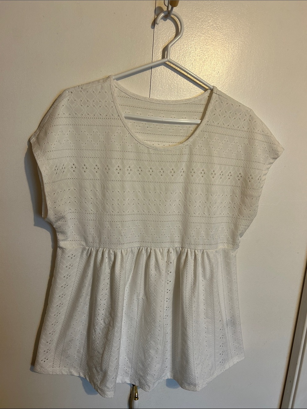 White Eyelet Top with peplum waist. Stretchy comfort.